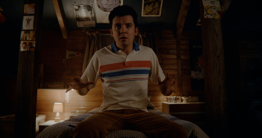 Asa Butterfield as Otis Milburn sits on his bed in Season 4 of 'Sex Education.'