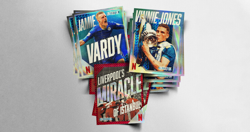 A stack of Netflix trading cards featuring football themes, including players in action and titles like "Jamie Vardy," "Vinnie Jones," and "Liverpool’s Miracle of Istanbul," photographed on a plain, light background.
