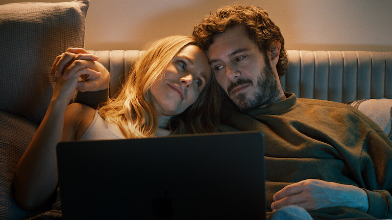 Kristen Bell as Joanne and Adam Brody as Noah snuggle on a couch together in Season 1 of 'Nobody Wants This'