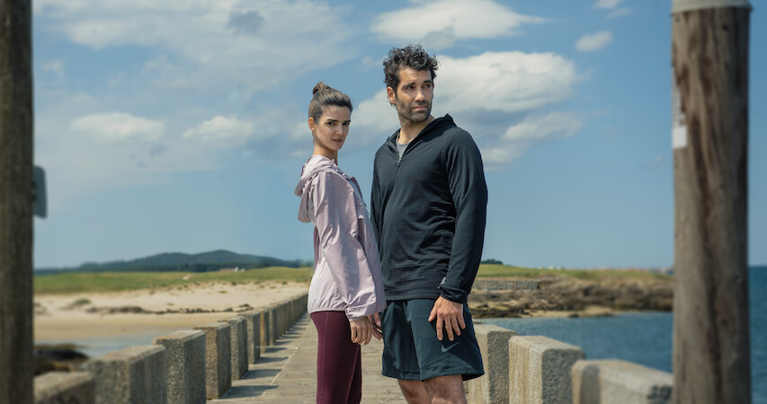 Clara Lago as Ana and Tamar Novas as Daniel stand together on a dock in 'Gangs of Galicia'