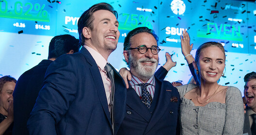 Chris Evans, Andy Garcia and Emily Blunt celebrate in a scene from 'Pain Hustlers.'