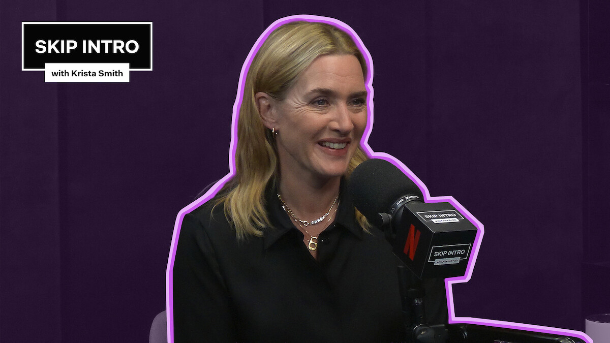 Kate Winslet smiles while speaking into a podcast microphone in a purple studio, outlined with a neon accent, with a “Skip Intro with Krista Smith” graphic in the corner.