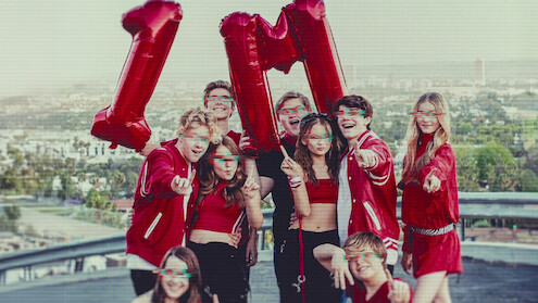 Kidfluencers pose with balloons that say 1M