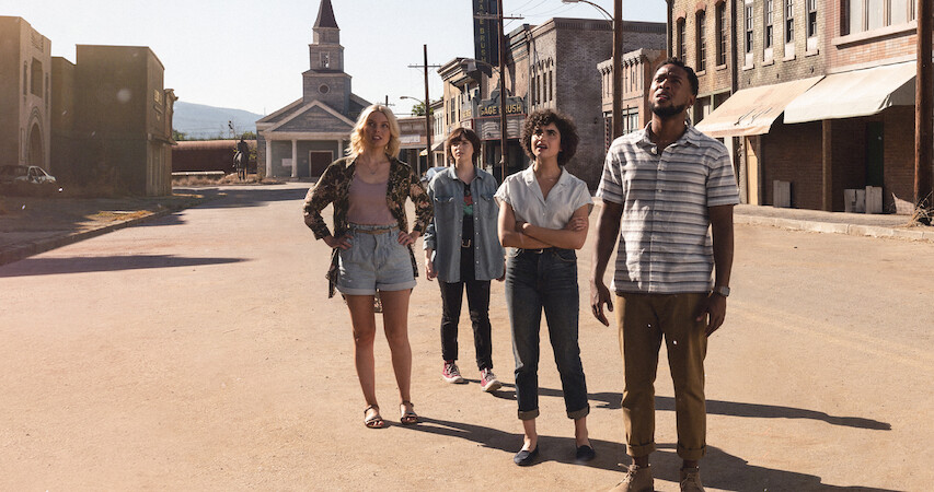 An image of the characters standing in the ghost town in Texas Chainsaw Massacre