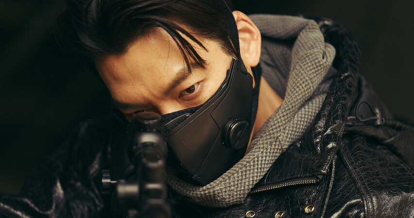 Actor Kim Woo-bin points a gun in a close-up still image from the series 'Black Knight.'