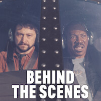 Detective Bobby Abbott (Joseph Gordon-Levitt) and Detective Axel Foley (Eddie Murphy) in the cockpit of a helicopter.
