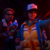 Two animated kids in winter clothes explore a dark cave; one holds a glowing flashlight and the other aims a futuristic gadget, both looking alert and determined in the mysterious, dimly lit environment.