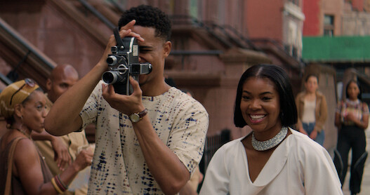 Keith Powers holds a camera next to Gabrielle Union in a still from 'The Perfect Find.'