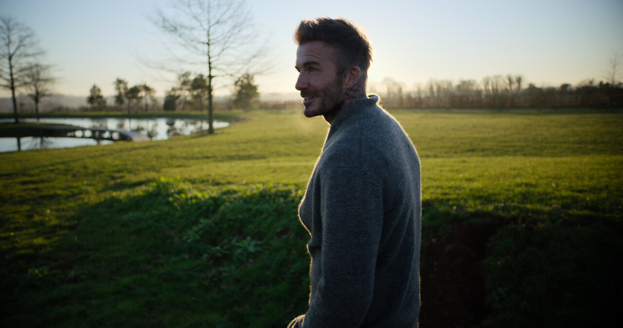 David Beckham standing outside.