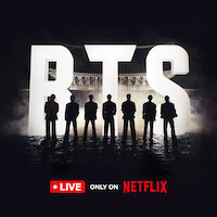 BTS standing silhouetted against giant 'BTS' letters