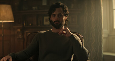 Penn Badgley's Joe Goldberg seated in a chair in You Season 4