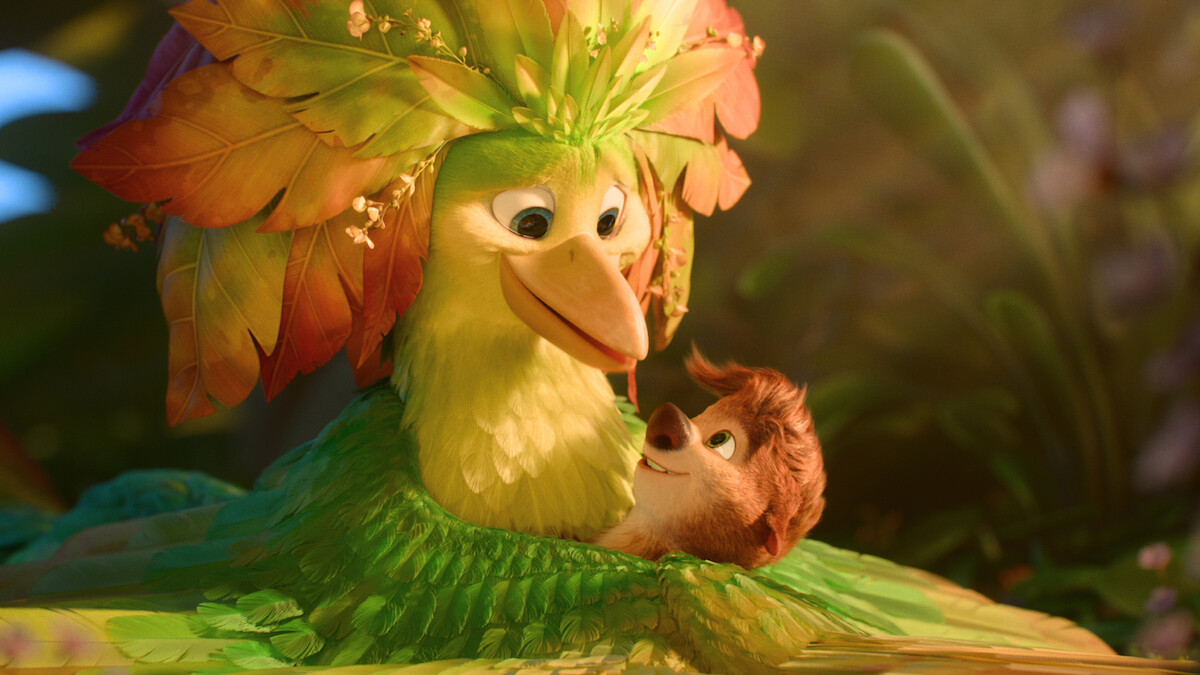 A colorful animated bird with leaf feathers lovingly embraces a small smiling animal in a lush, vibrant jungle environment with soft light and green foliage in the background.