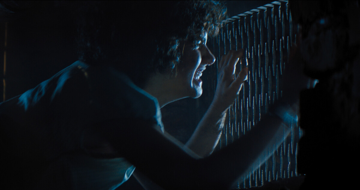 A terrified Melody peeks through a grate to get away