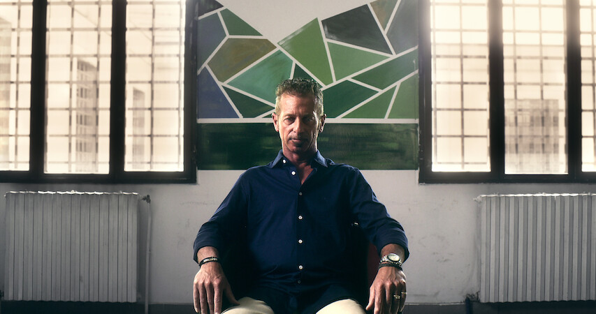 A man sits on a chair with a defeated expression in 'The Yara Gambirasio Case: Beyond Reasonable Doubt'
