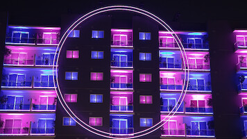 An exterior view of 'The Circle' apartments from Season 6.