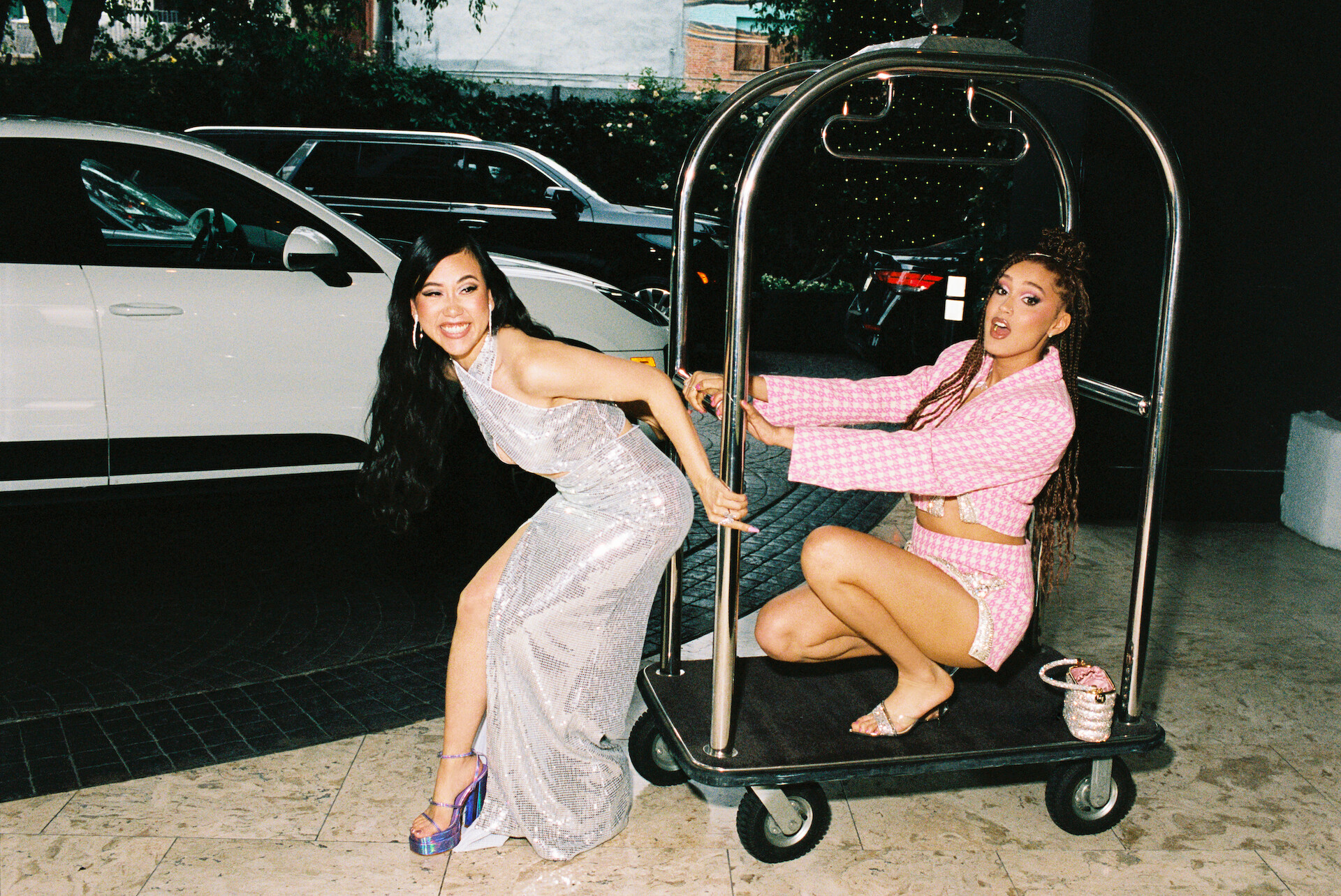 Ramona Young and Lee Rodriguez on a luggage cart