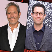 Two men in business attire, both smiling. The left man is standing in front of a pink background. The right man has dark hair, glasses, and a suit, with a black and white patterned backdrop.