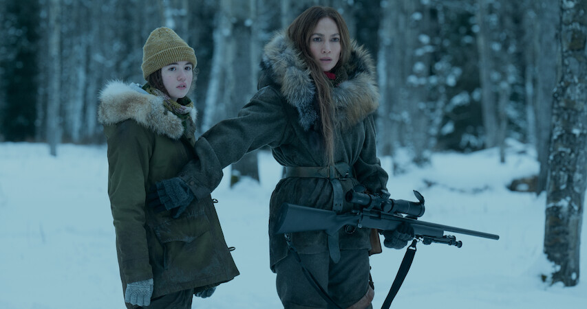 Lucy Paez (left) and Jennifer Lopez (right) stand side by side in the snow in a still from 'The Mother.'