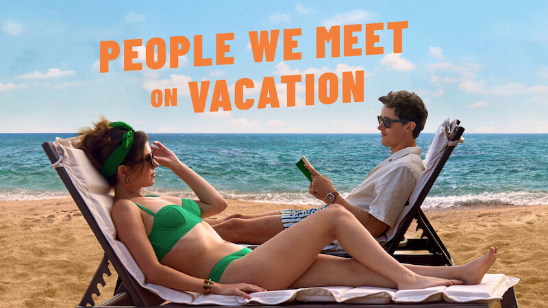 Two people on sun loungers on the beach