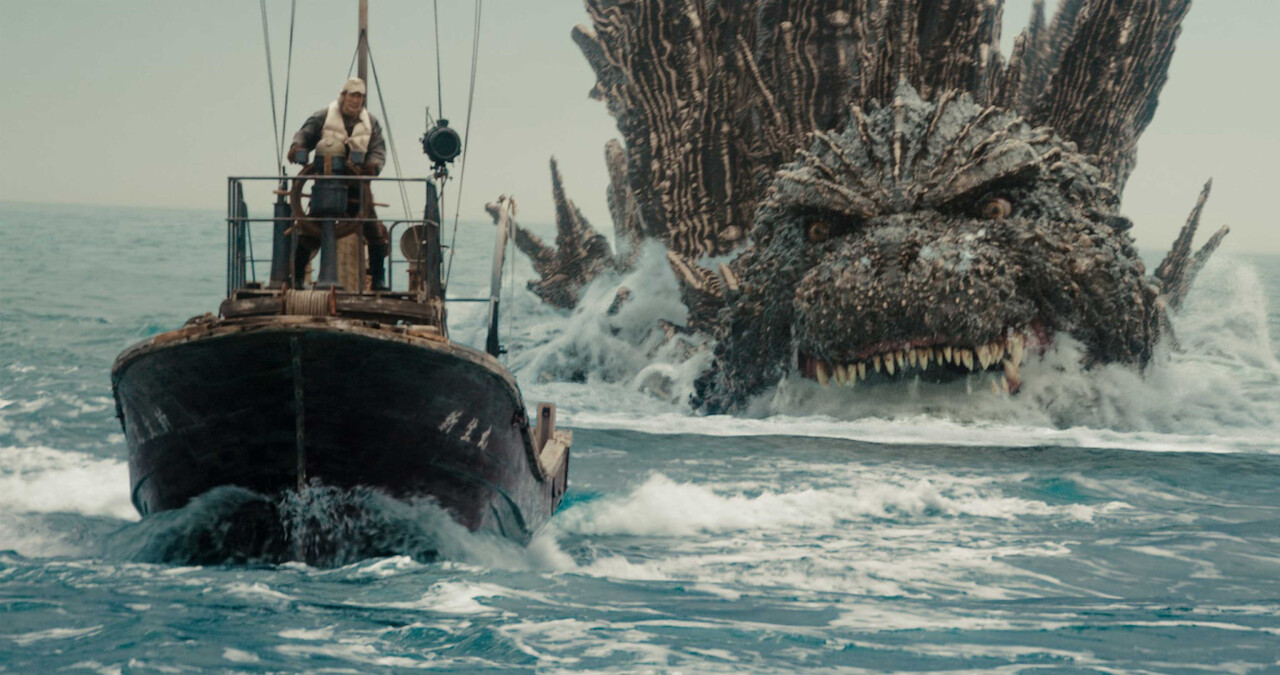 Godzilla chases closely behind a boat in 'Godzilla Minus One.'