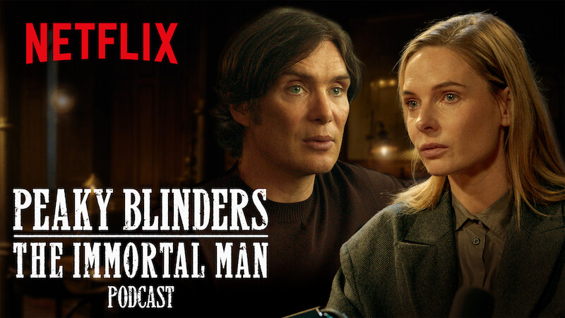 Two serious people sit indoors, warmly lit, in a conversation setting. The Netflix logo and "Peaky Blinders: The Immortal Man Podcast" text is displayed prominently in white across the image.
