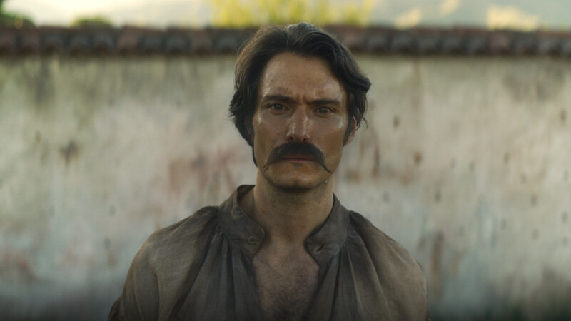 Claudio Cataño as Colonel Aureliano Buendía stands with an intense introspective expression in 'One Hundred Years of Solitude'