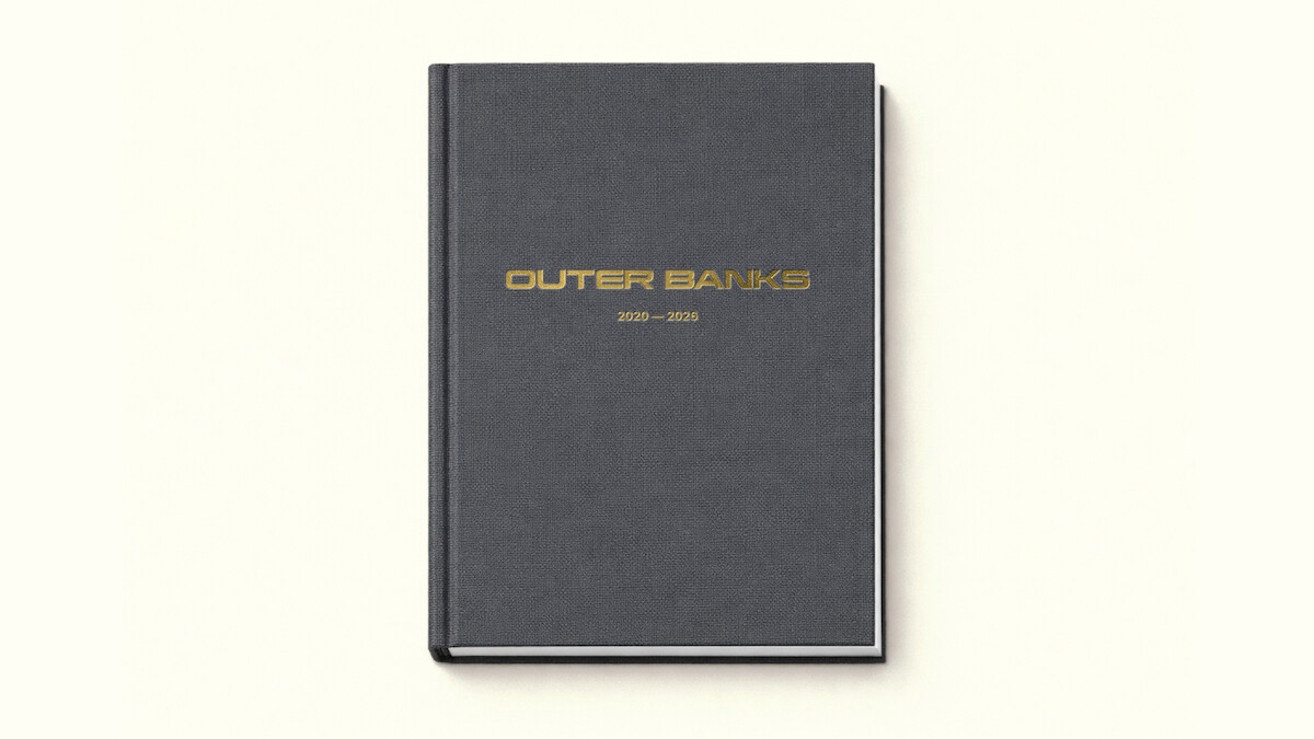 A black hardcover book with gold "Outer Banks 2020–2025" text on the cover, photographed on a plain off-white background.