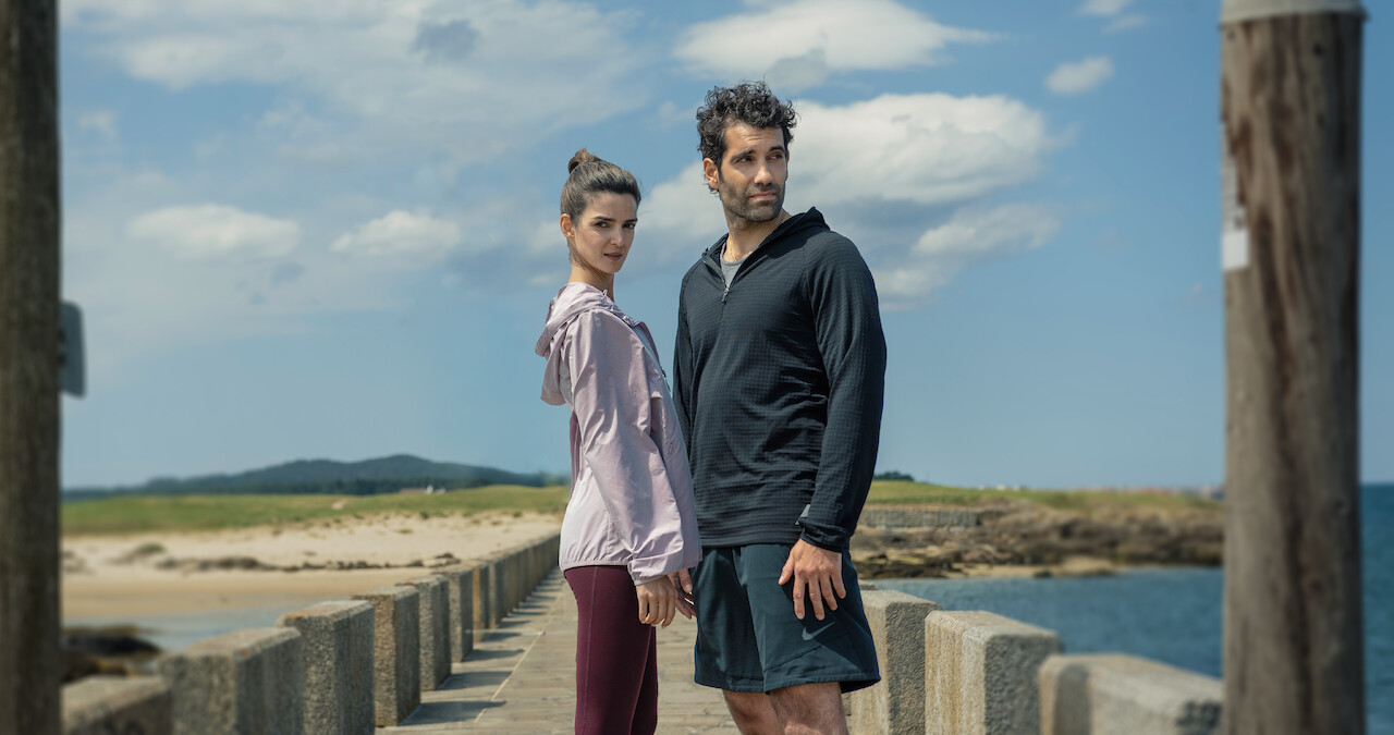 Clara Lago as Ana and Tamar Novas as Daniel stand together on a dock in 'Gangs of Galicia'