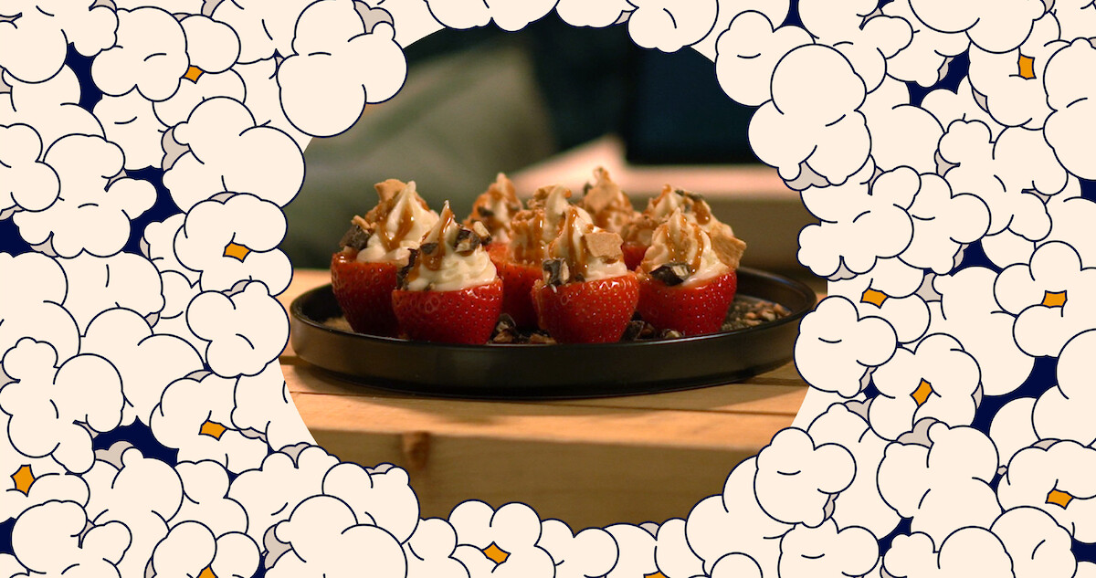 An image of popcorn with cheesecake stuffed strawberries in the middle 