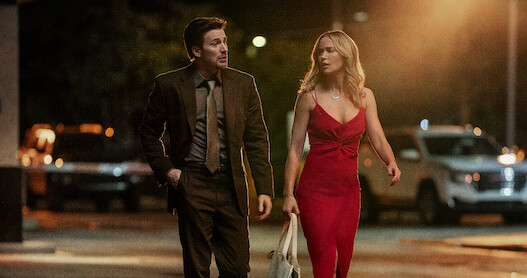 Chris Evans as Pete Brenner and Emily Blunt as Liza.