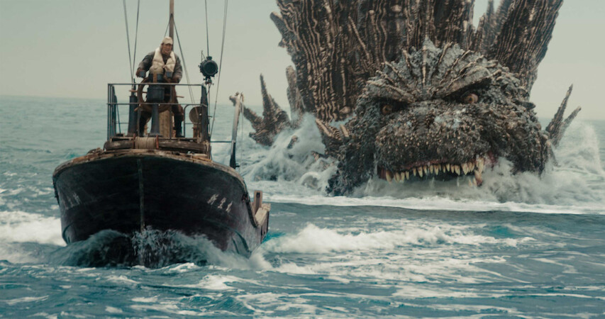 Godzilla chases closely behind a boat in 'Godzilla Minus One.'