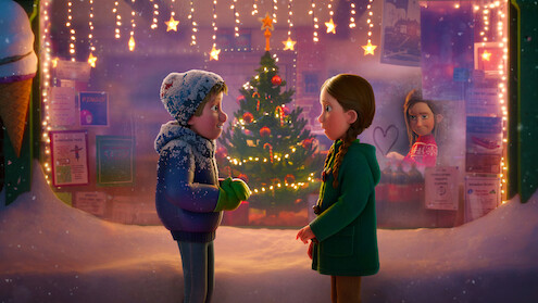 Instream still from 'That Christmas', featuring a young boy and girl in front a Christmas tree and Christmas lights.