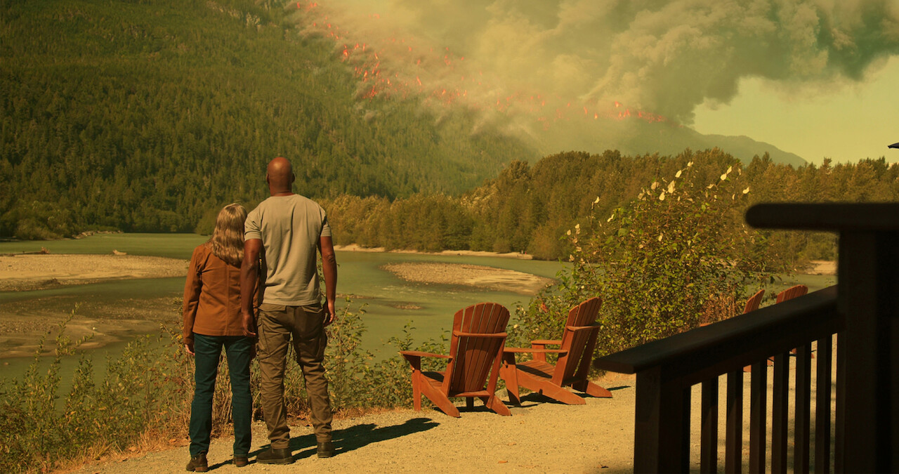 Annette O’Toole as Hope and Colin Lawrence as Preacher watch a wildfire blazes through the mountainside in Season 5 of 'Virgin River.'