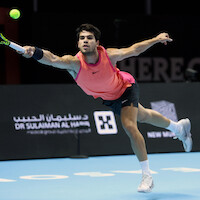 Carlos Alcaraz hitting an outstretched forehand shot during The 2024 6 Kings Slam