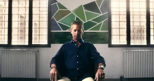 A man sits on a chair with a defeated expression in 'The Yara Gambirasio Case: Beyond Reasonable Doubt'
