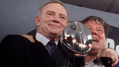 Jerry Jones holding the Vince Lombardi Trophy