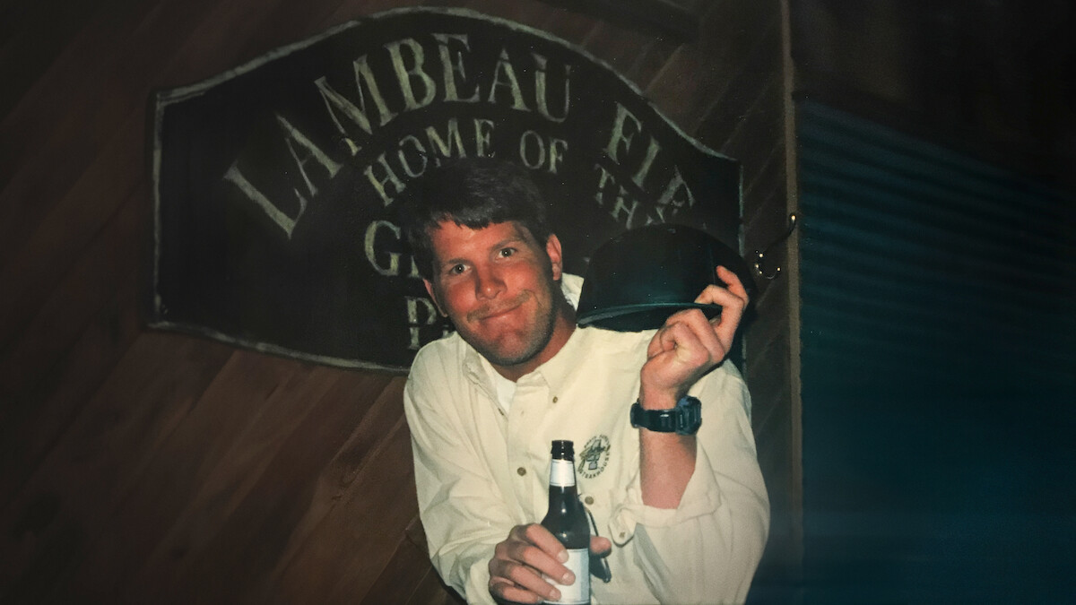 Brett Favre holding a beer and a helmet