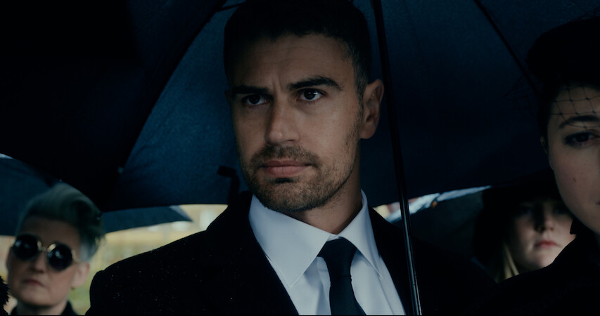 Theo James as Eddie Horniman wears a suit and holds an umbrella in season 1 of 'The Gentlemen'