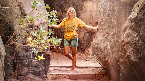 A photograph of Gabby Petito posing on a trail. 