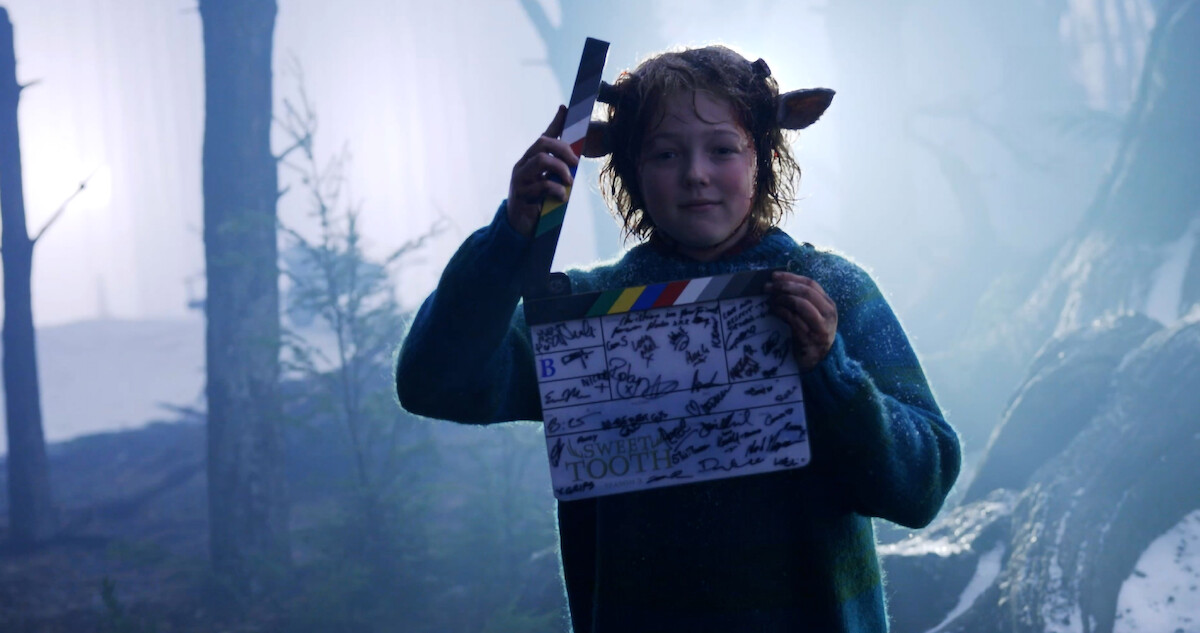 Christian Convrey as Gus holds a clap board in this behind the scenes shot from Season 3 of 'Sweet Tooth'