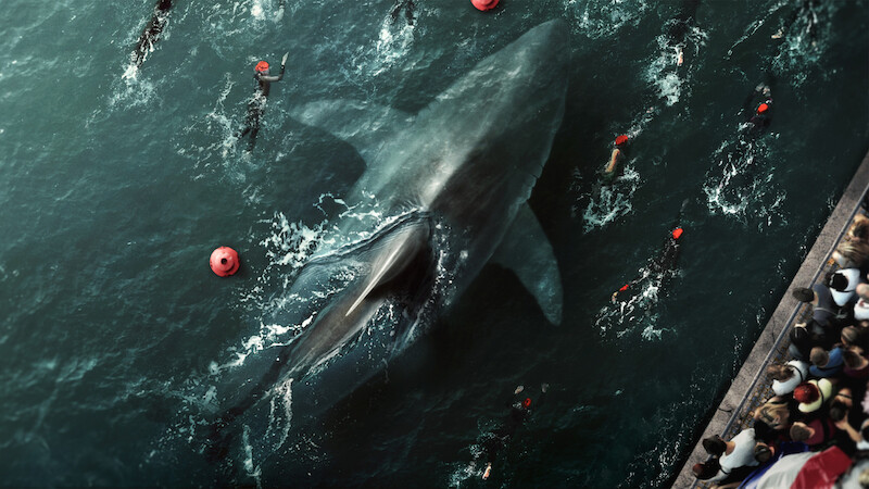 People swim around a giant shark in the Seine in 'Under Paris.'
